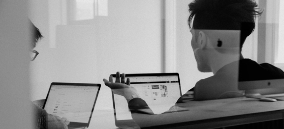 two persons using computers