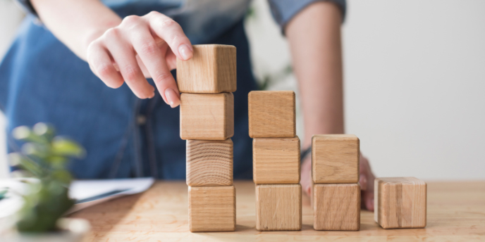 woman stacking wooden squares