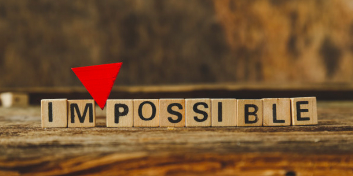 word “impossible” written with wooden squares