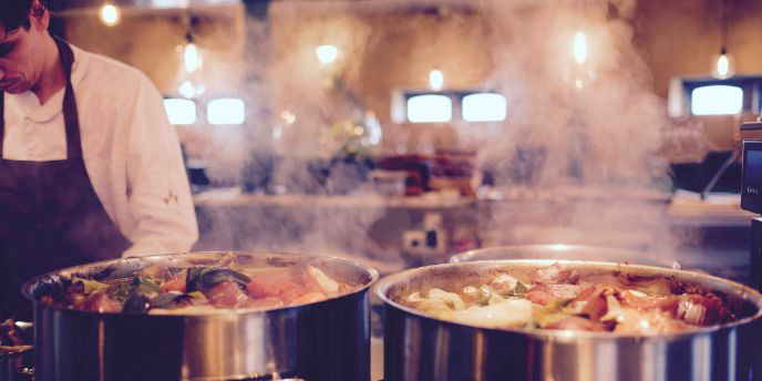 chef cooking vegetables in two pots