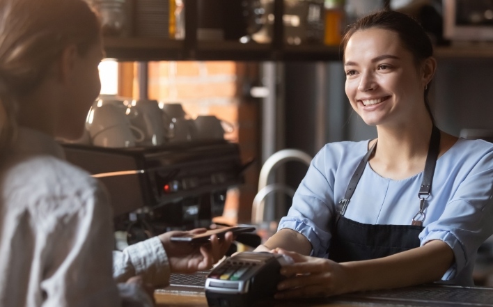 woman making payments with her cell phone