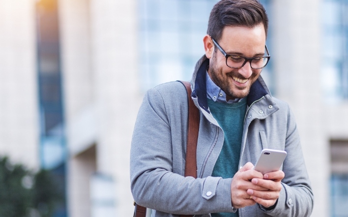 male IT professional using his mobile device
