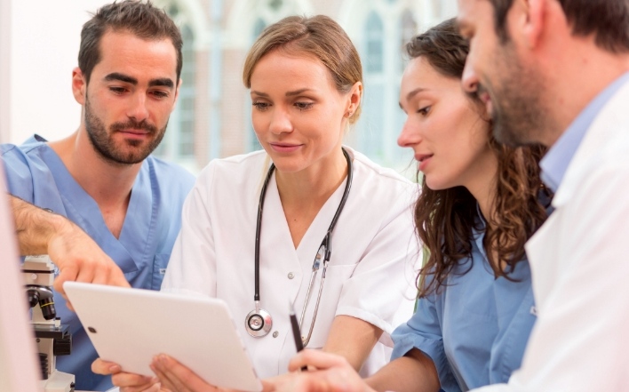 healthcare professionals checking a tablet device
