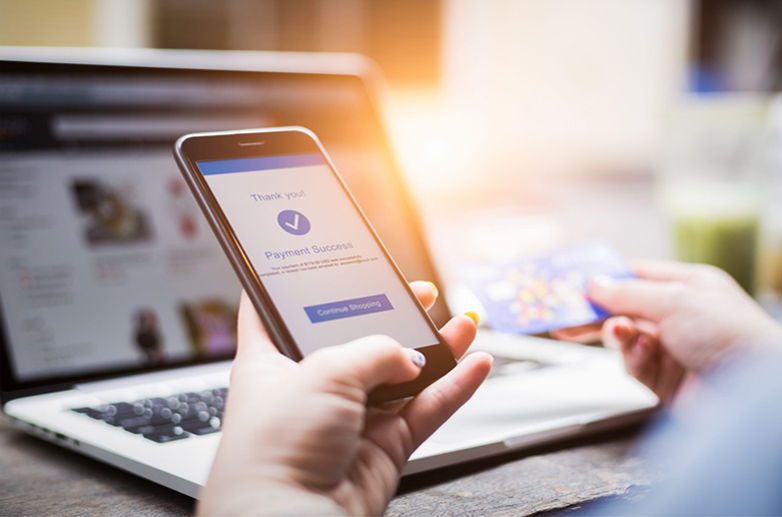woman paying online through a mobile phone