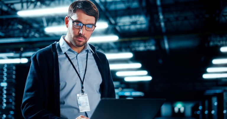 data center IT specialist using laptop computer