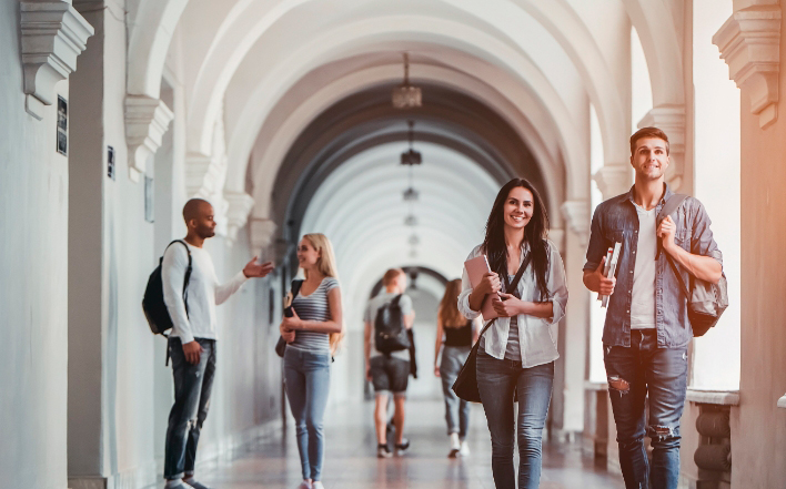 students walking down the hall of the university