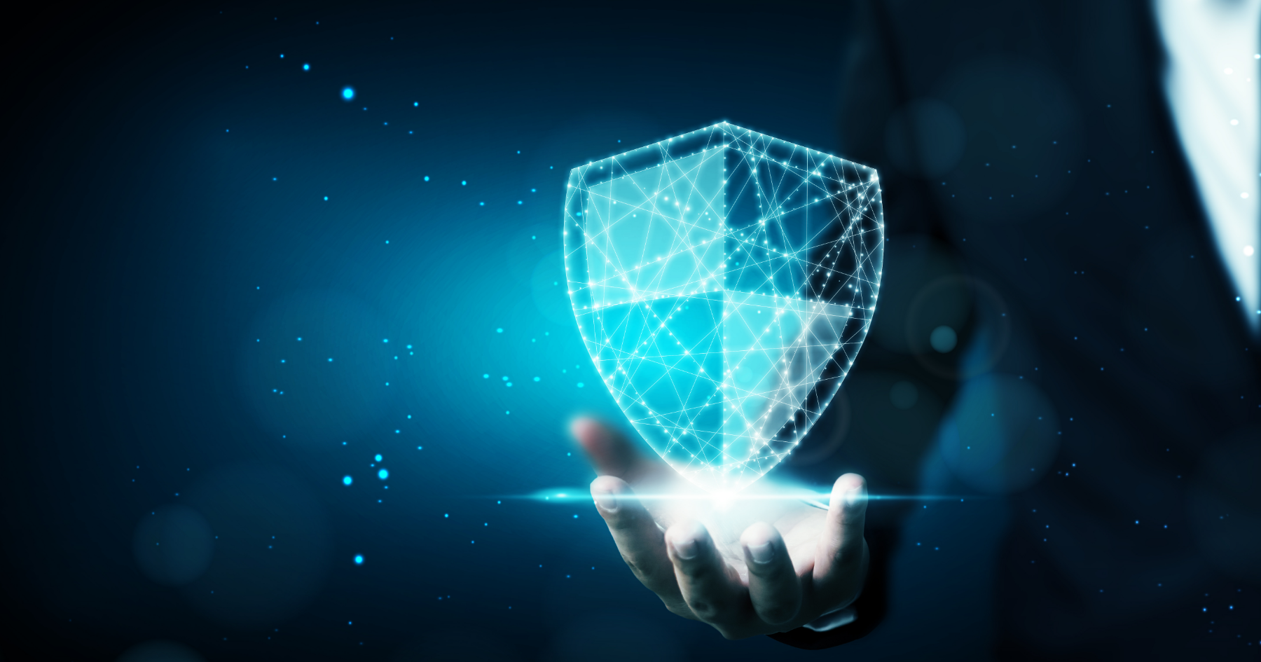 Digital shield hovering above a hand illustrating AI protection and collaboration