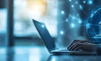 Person typing on a laptop with holographic banking and security icons, representing digital banking, fintech security, and online financial services.
